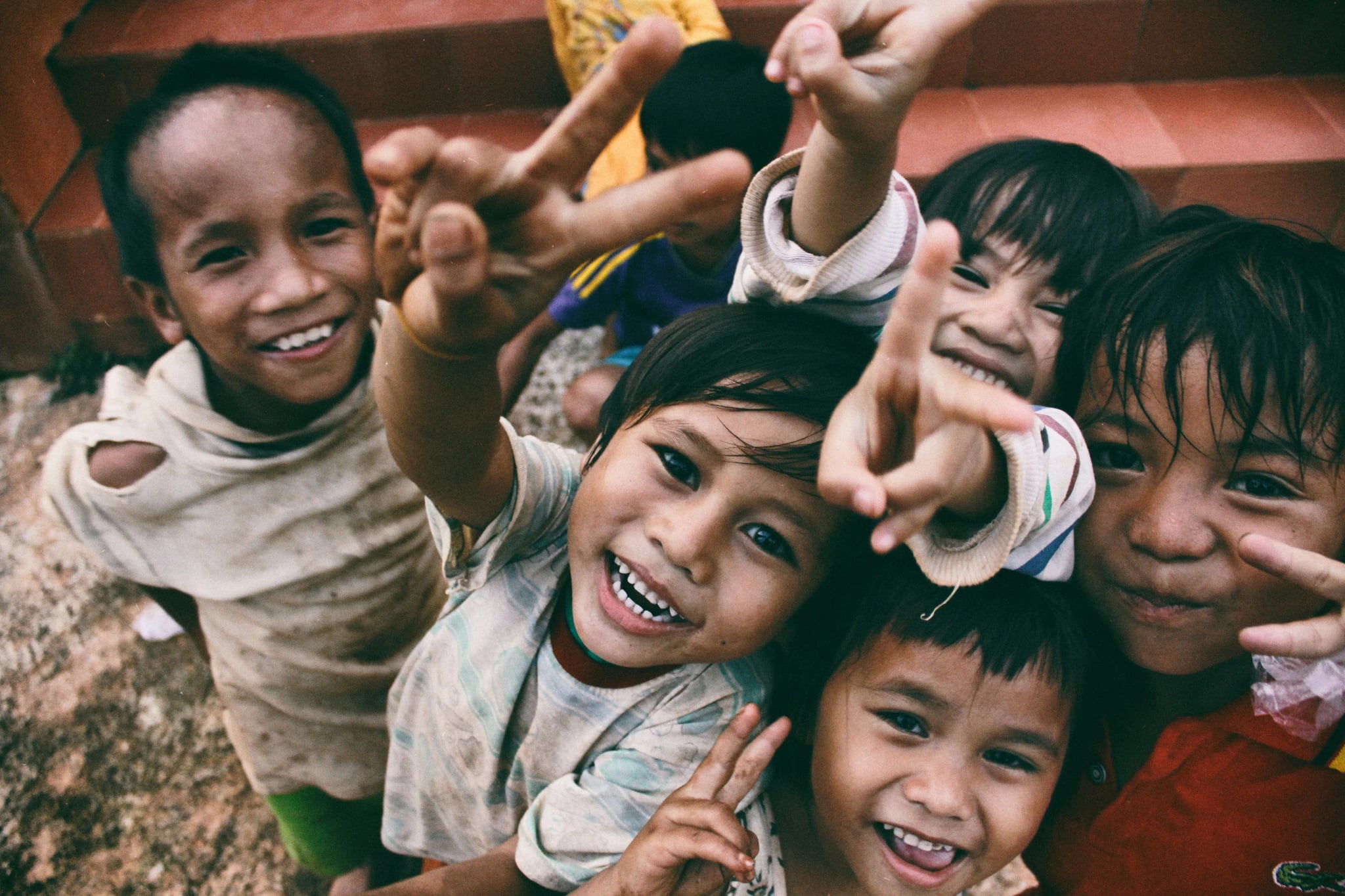 Children reaching out towards the camera
